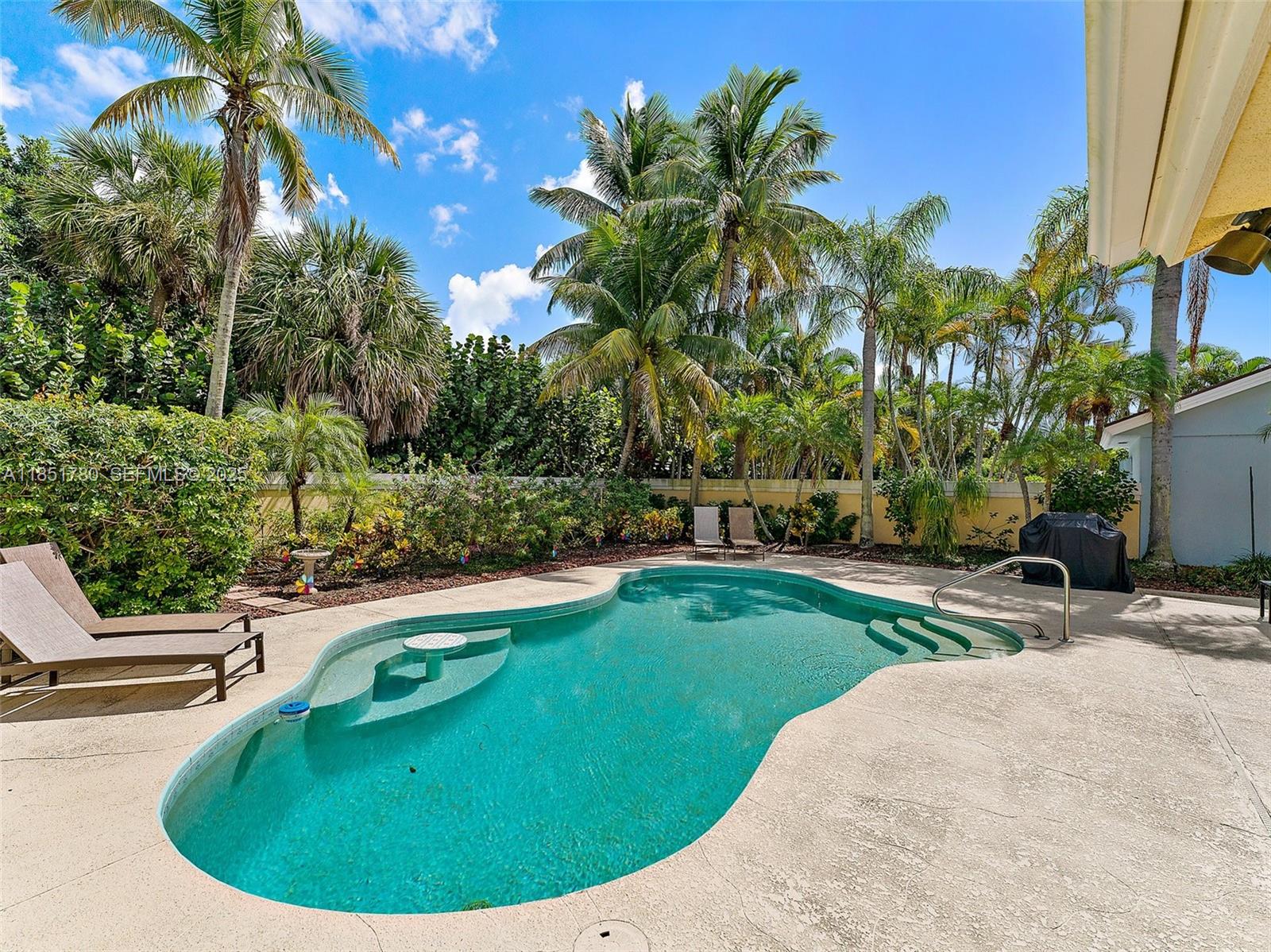 101 Sand Pine Drive, Unit 101 Jupiter, FL 33477 - Photo 27 of 33 a view of a swimming pool with a sitting space