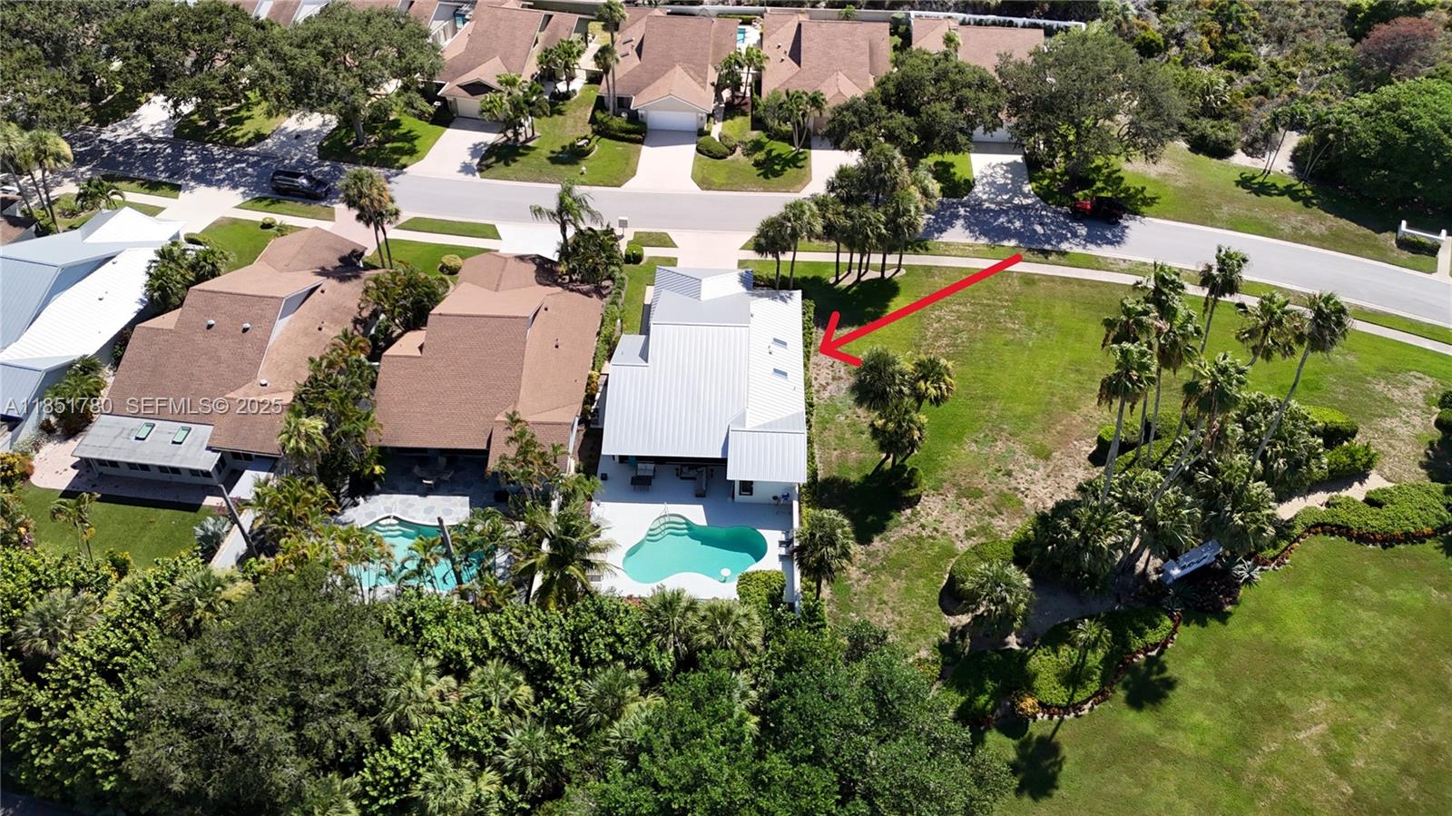 101 Sand Pine Drive, Unit 101 Jupiter, FL 33477 - Photo 29 of 33 an aerial view of residential houses with outdoor space