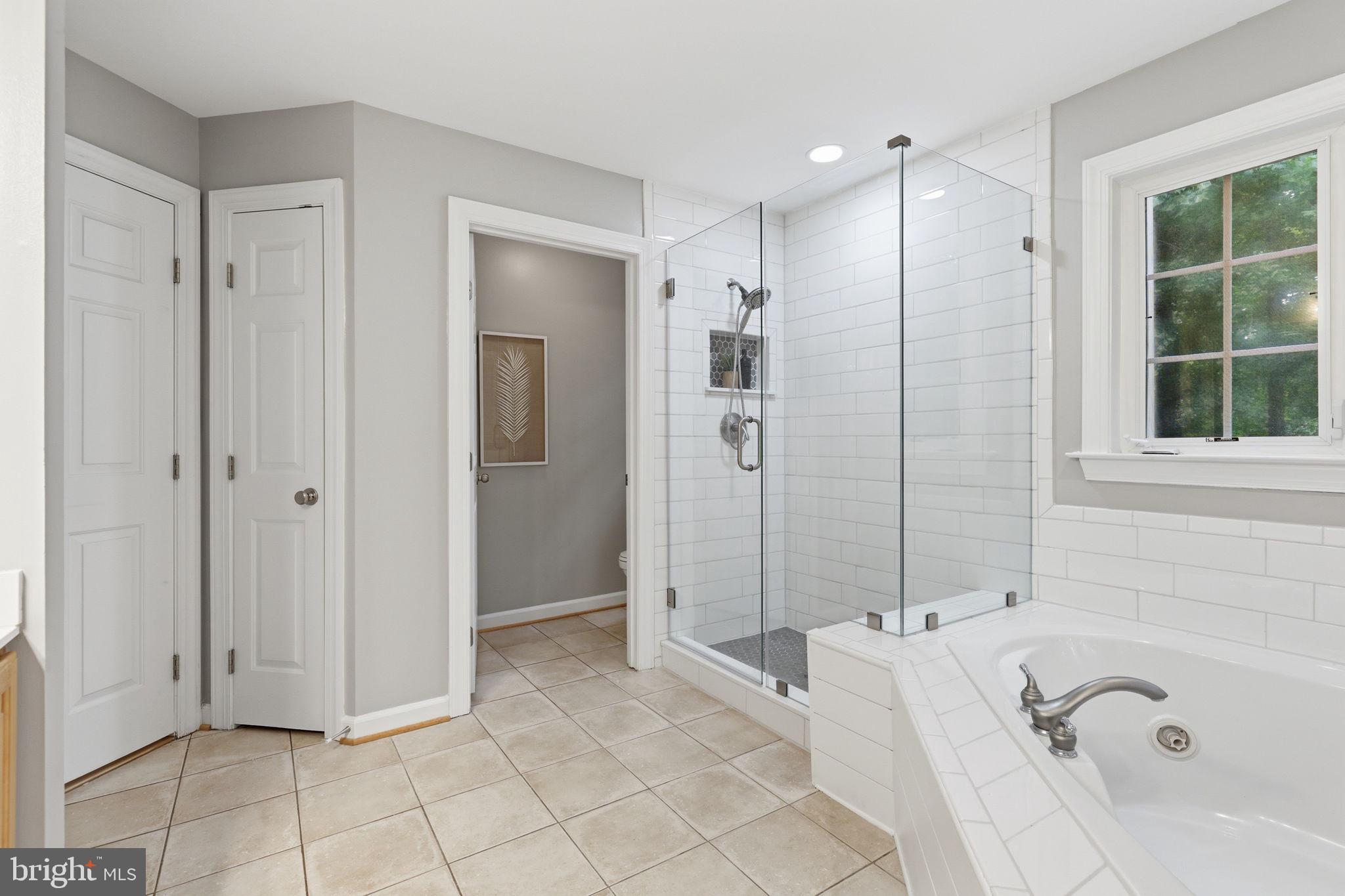 11509 Summit Ridge Court Manassas, VA 20112 - Photo 29 of 43 a spacious bathroom with a tub shower and windows