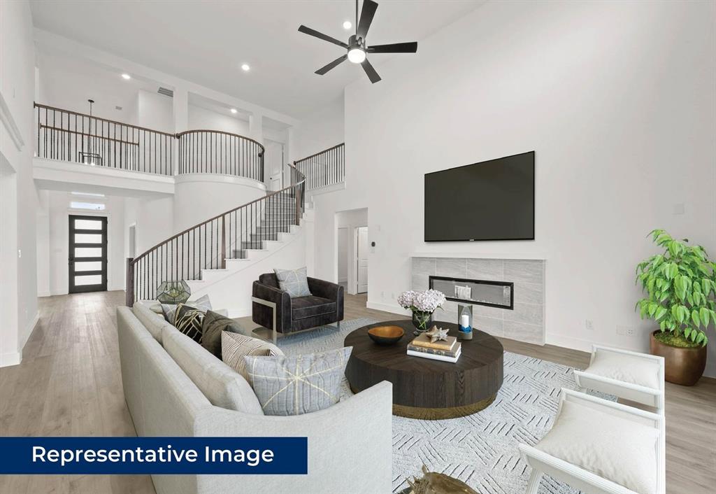 14930 Shoal Valley Road Frisco, TX 75035 - Photo 5 of 8 a living room with furniture and a flat screen tv