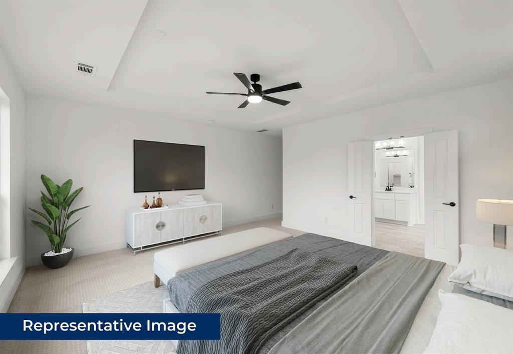 14930 Shoal Valley Road Frisco, TX 75035 - Photo 6 of 8 a bedroom with a bed and a flat screen tv