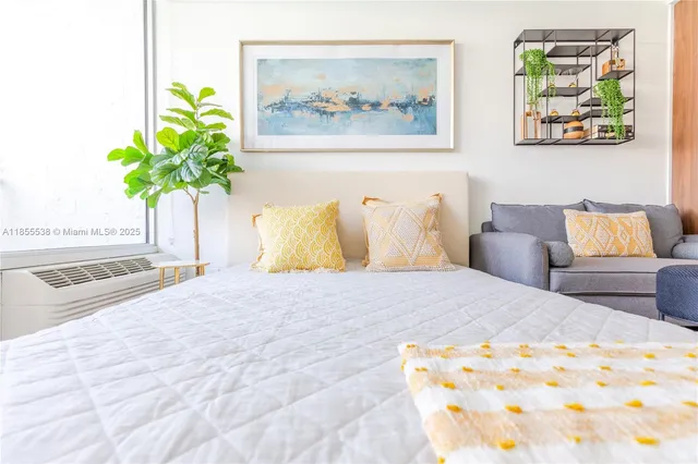 a bedroom with a bed and a painting on the wall