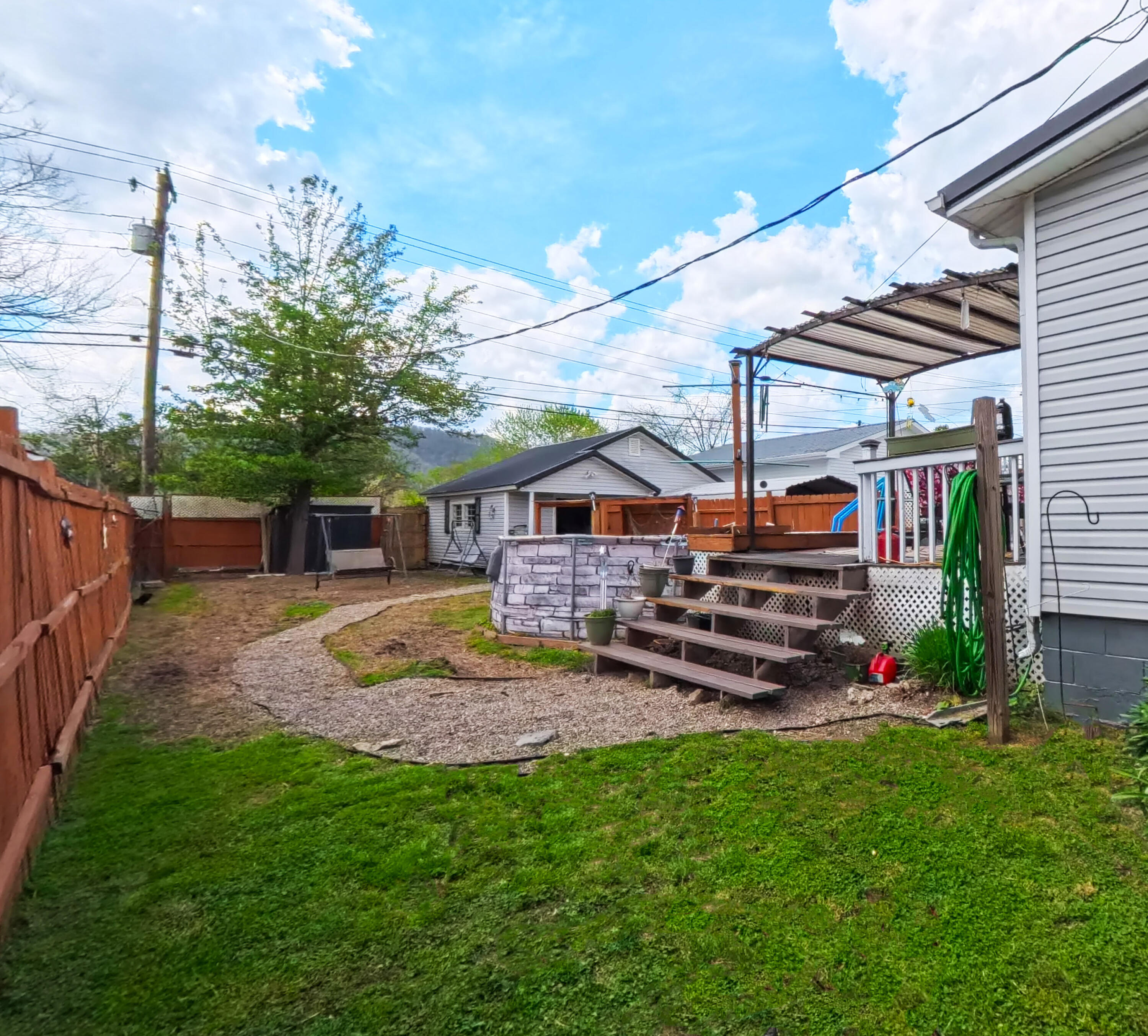 413 Elm Street Ravenna, KY 40472 - Photo 28 of 42 Side yard with walkway to the garage.