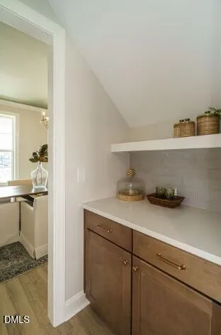 a dining room with furniture a chandelier and wooden floor