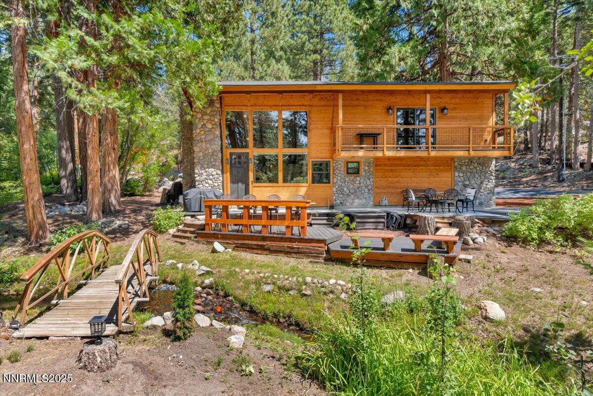 a view of a house with backyard sitting area and garden