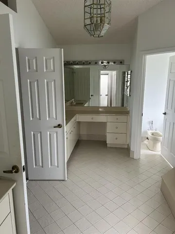a large white kitchen with a sink