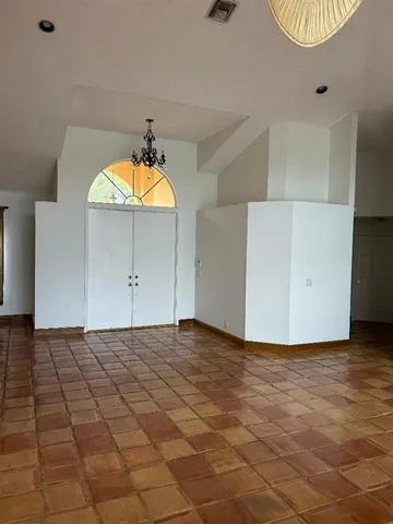 a view of a livingroom with wooden floor and a ceiling fan