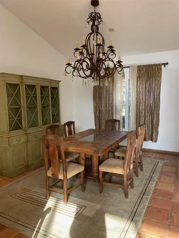a view of a dining room with furniture and window