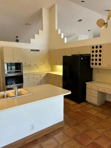 a kitchen with a sink and a stove top oven