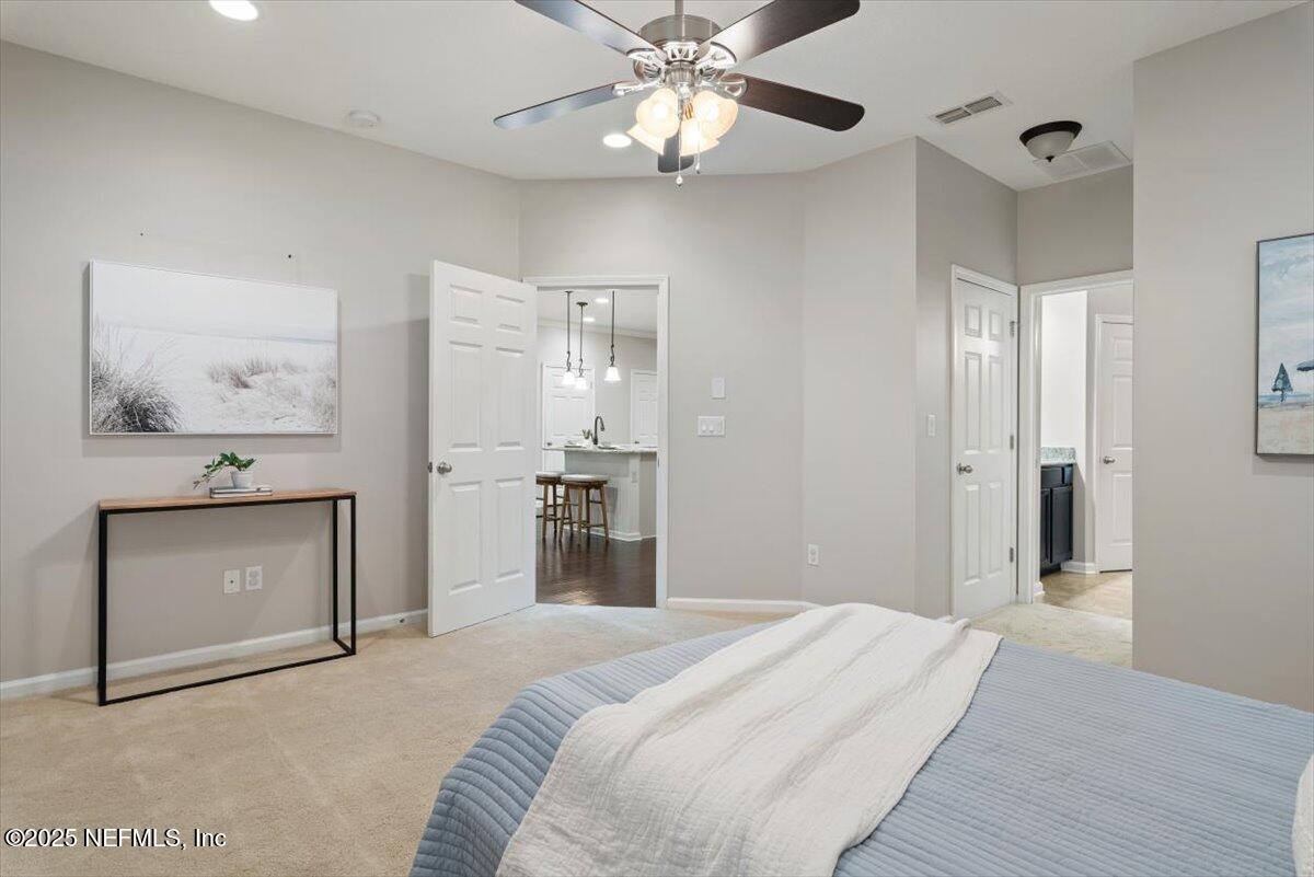 47 Myrtle Park Point Ponte Vedra, FL 32081 - Photo 20 of 58 a bedroom with a bed and a chandelier
