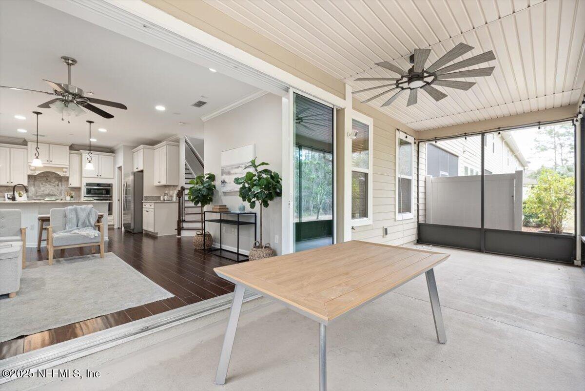 47 Myrtle Park Point Ponte Vedra, FL 32081 - Photo 25 of 58 a dining hall with stainless steel appliances kitchen island granite countertop a table chairs and a refrigerator