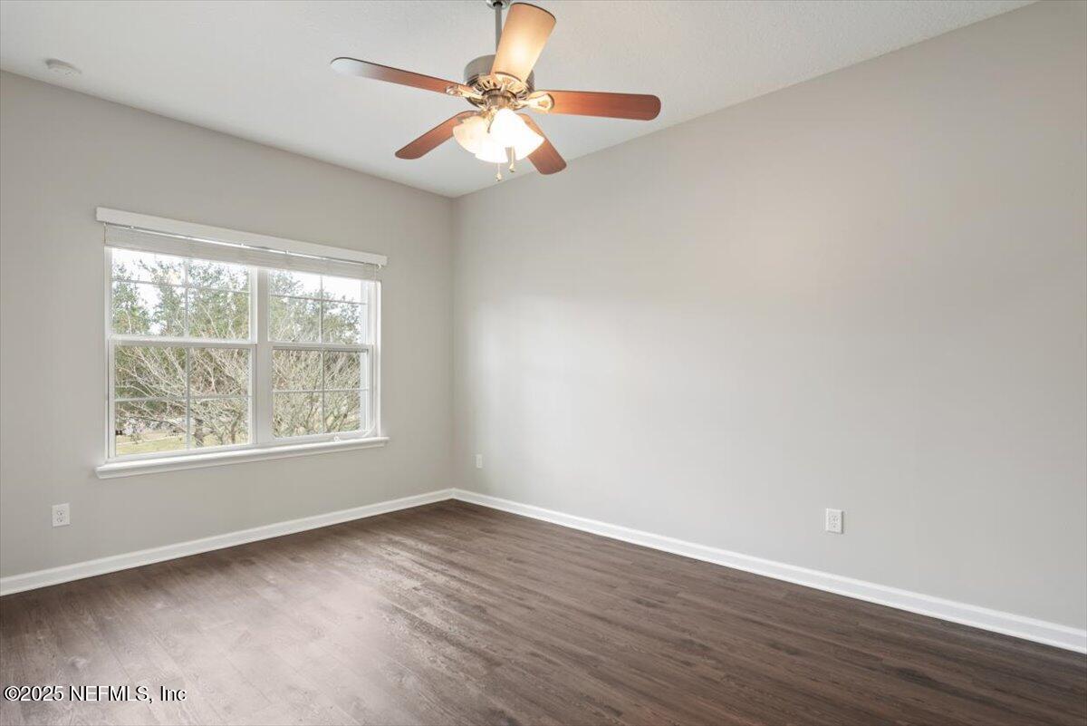 47 Myrtle Park Point Ponte Vedra, FL 32081 - Photo 30 of 58 an empty room with wooden floor fan and windows