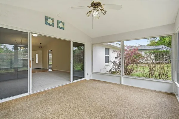 a view of a room with sliding glass door and balcony
