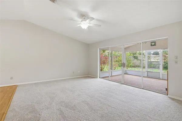 an empty room with windows and city view