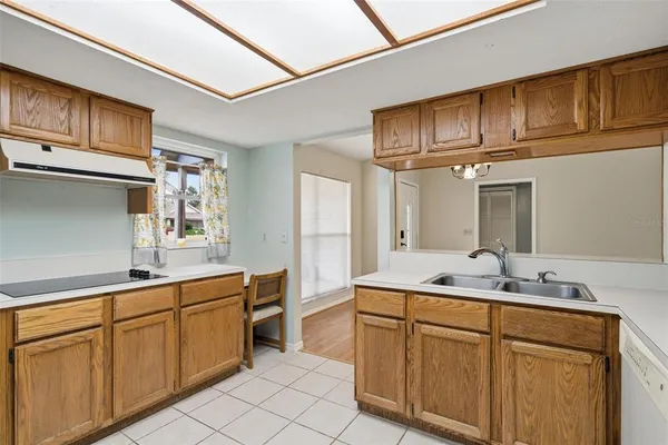 a kitchen with cabinets stainless steel appliances a sink and cabinets