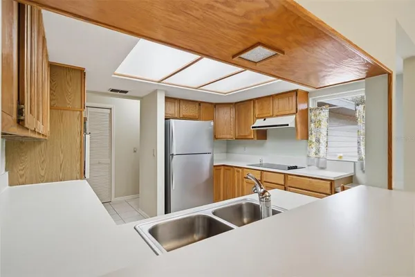a kitchen with stainless steel appliances a sink and a refrigerator