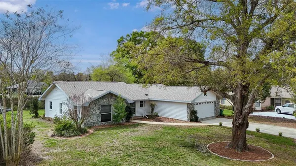 a front view of house with yard and trees