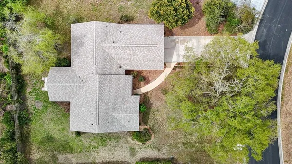 an aerial view of residential house with outdoor space and trees