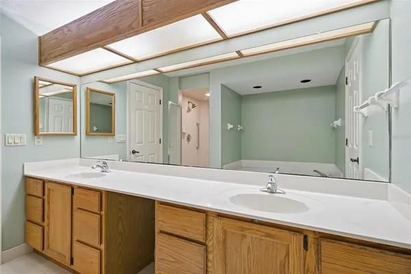 a bathroom with a sink double vanity granite and a mirror