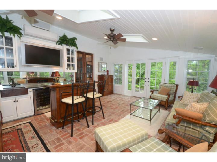 642 Mount View Road Berwyn, PA 19312 - Photo 6 of 25 a living room with furniture a flat screen tv and a large window