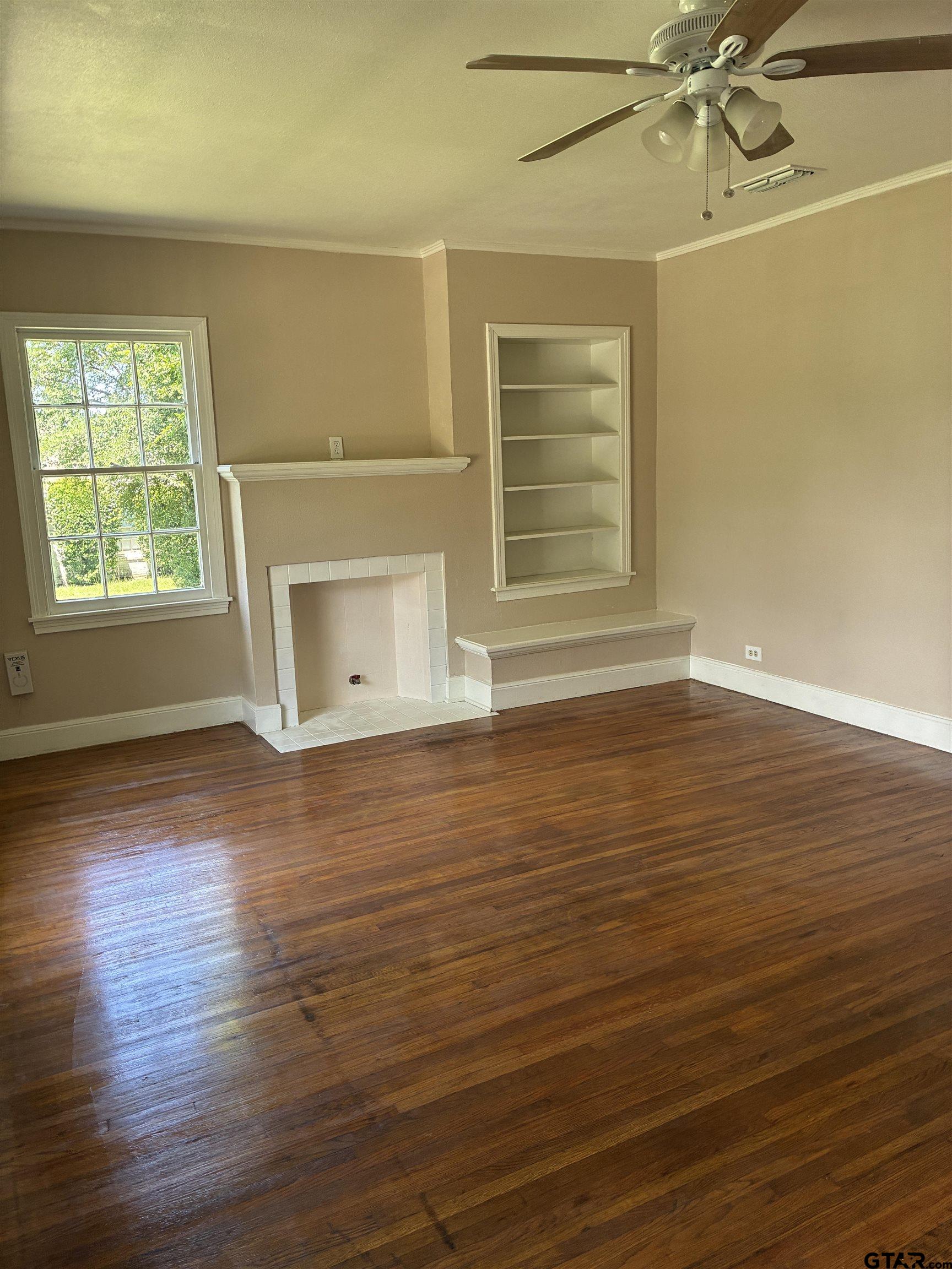 811 West 5th Street Tyler, TX 75701 - Photo 3 of 26 an empty room with wooden floor and windows