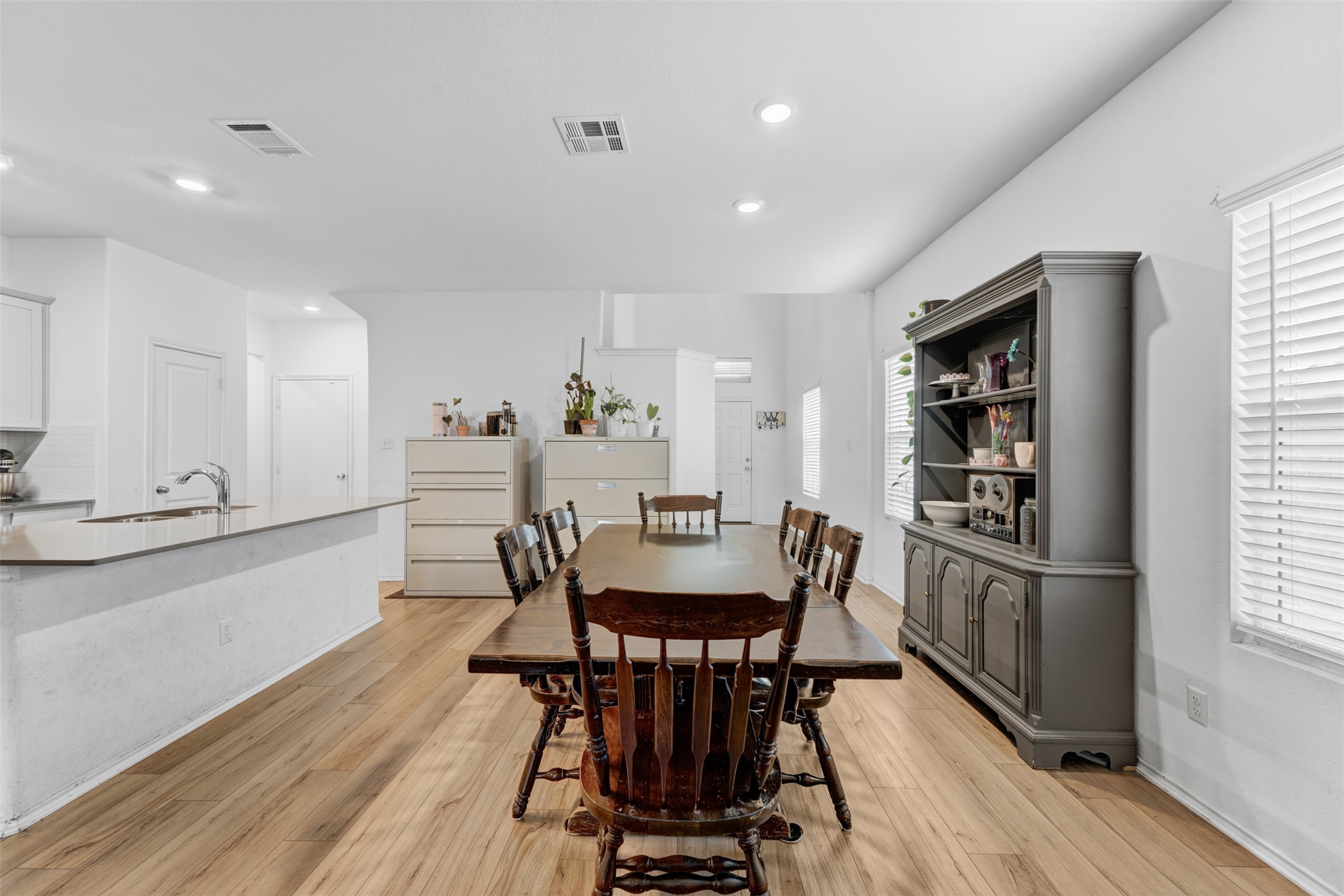 413 Perfect World Loop Jarrell, TX 76537 - Photo 8 of 39 Natural light illuminates this dining area, complete with sleek flooring and modern recessed lighting.
