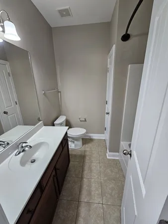 a spacious bathroom with a sink a toilet and a shower