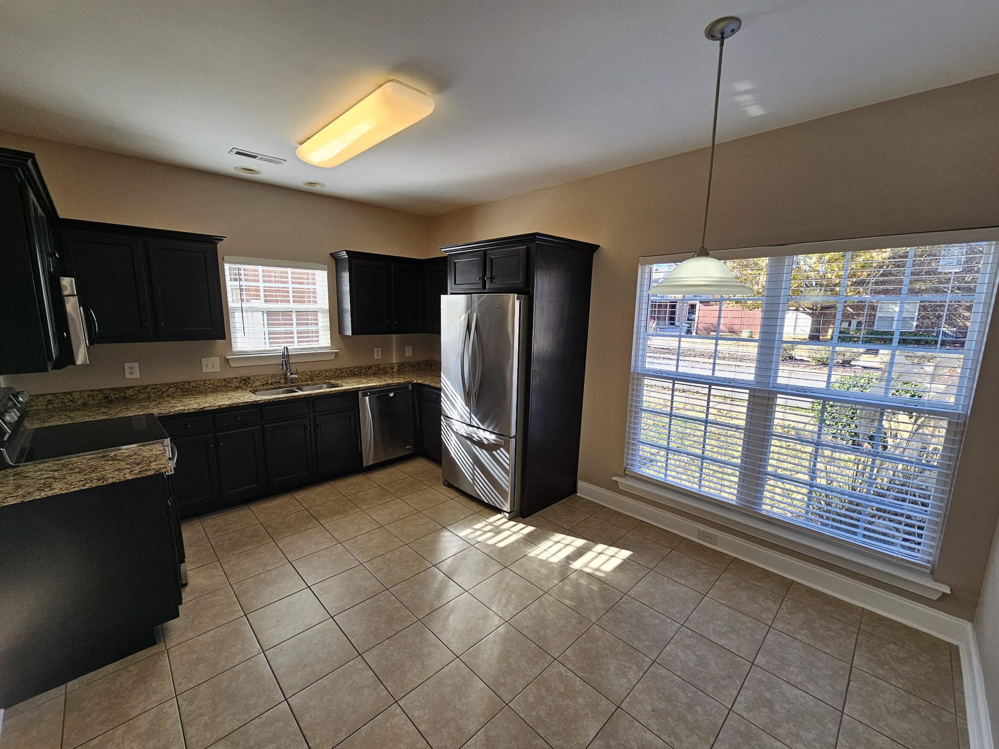 322 Rowlette Circle Murfreesboro, TN 37127 - Photo 3 of 23 a kitchen with stainless steel appliances granite countertop a refrigerator a sink a stove a microwave and island