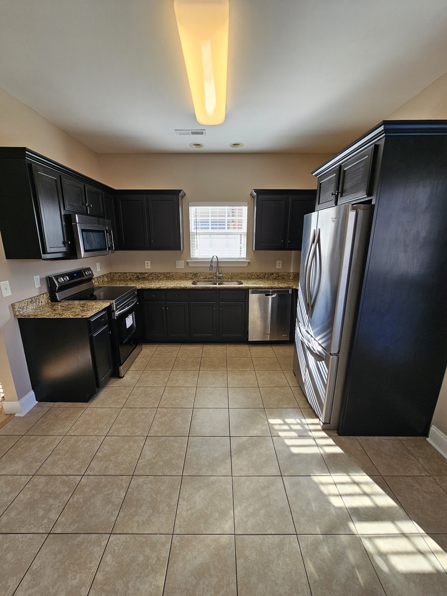322 Rowlette Circle Murfreesboro, TN 37127 - Photo 5 of 23 a kitchen with stainless steel appliances granite countertop a refrigerator and a stove top oven