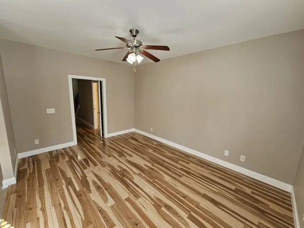 wooden floor in an empty room with a window
