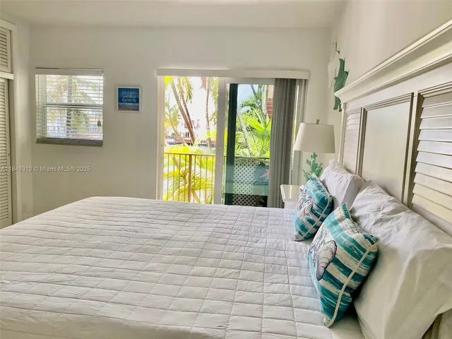 a bedroom with a bed and sliding window