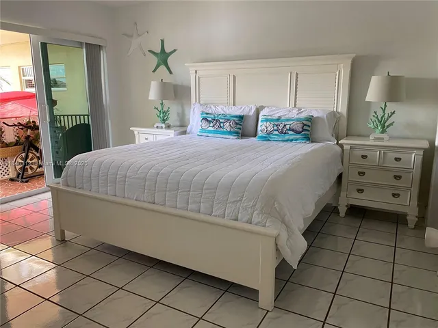 a bedroom with a bed and a potted plant