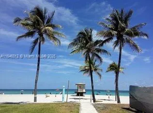 a view of a palm tree with a yard