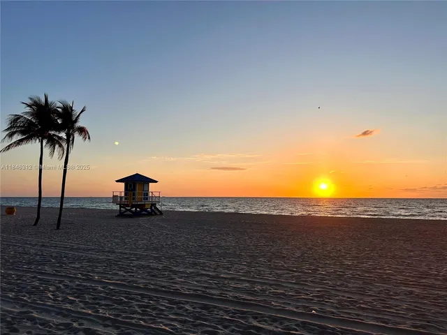 a view of a room with table & chairs