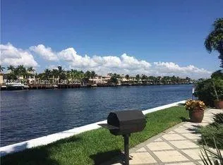 a lake view with a bench and trees