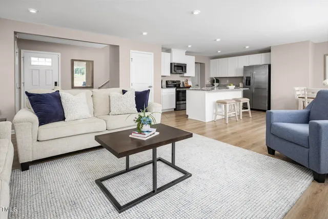 a kitchen with stainless steel appliances granite countertop a sink stove microwave and refrigerator