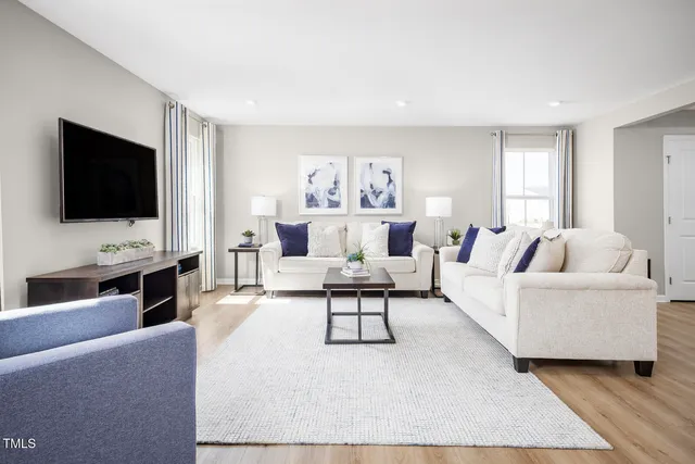 a living room with furniture and kitchen view