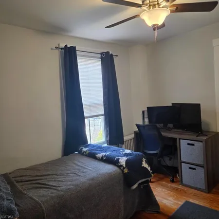 a bedroom with a bed and a desk