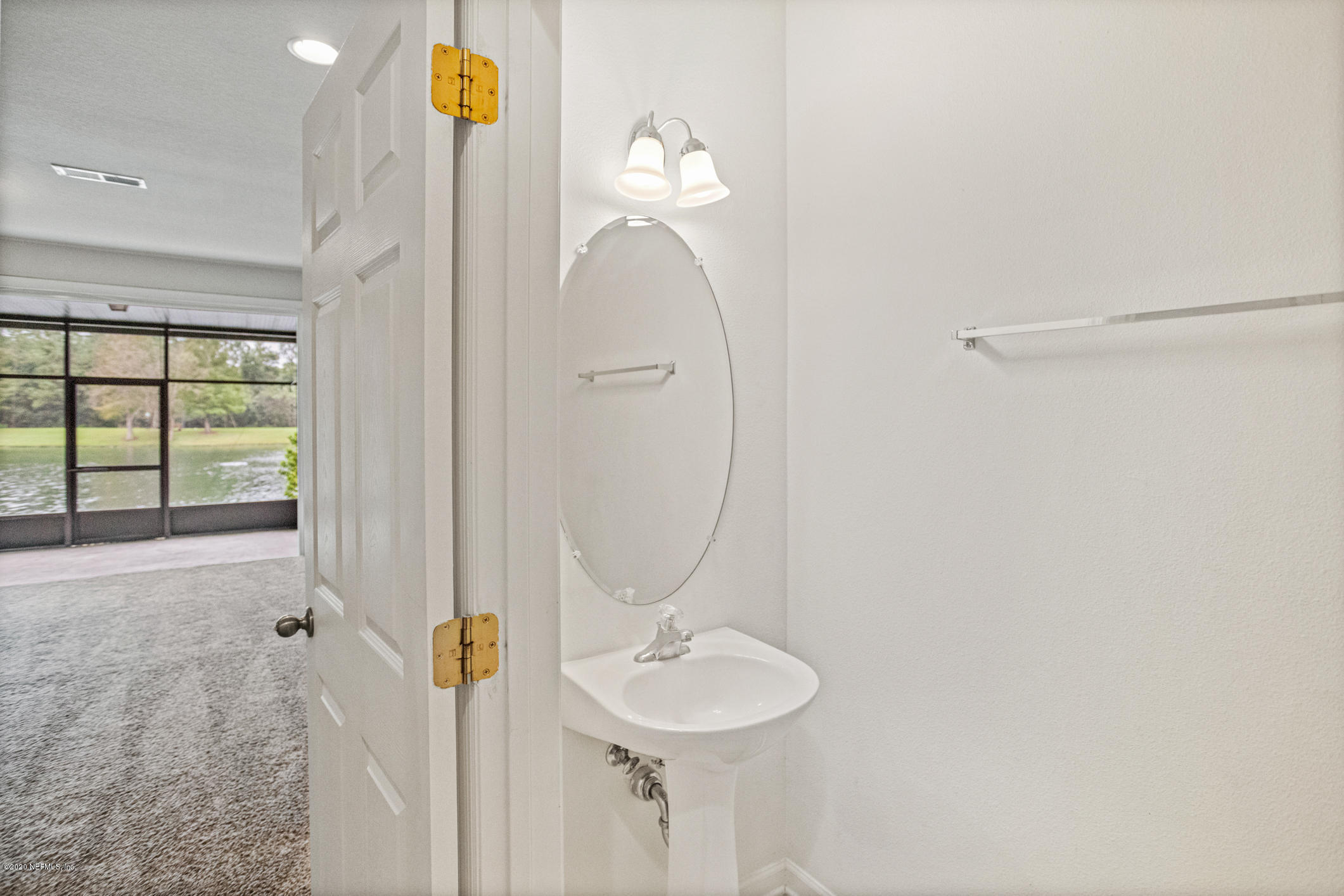 5784 Sandstone Way Jacksonville, FL 32258 - Photo 13 of 29 a bathroom with a sink and a mirror