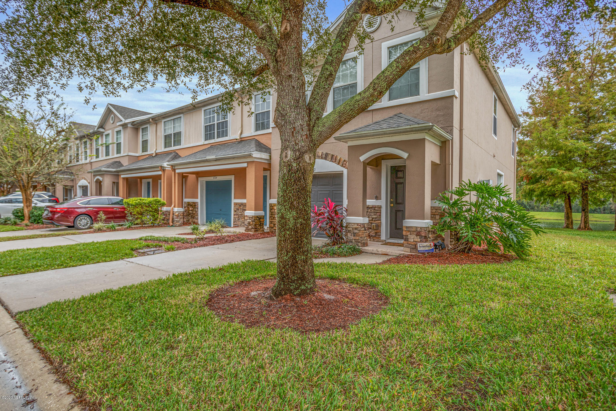 5784 Sandstone Way Jacksonville, FL 32258 - Photo 22 of 29 a front view of a house with garden and porch