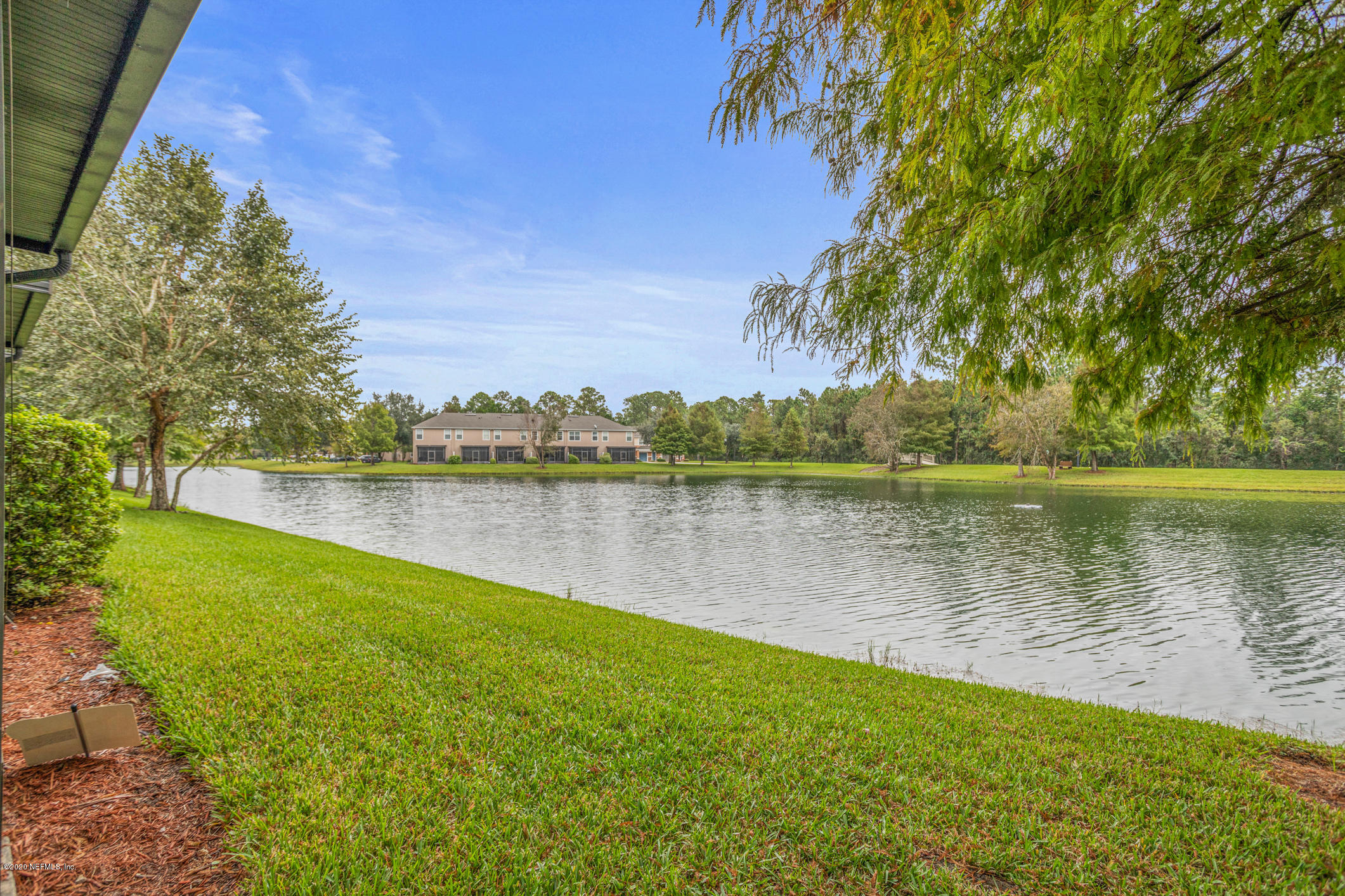 5784 Sandstone Way Jacksonville, FL 32258 - Photo 23 of 29 a view of a lake with a big yard