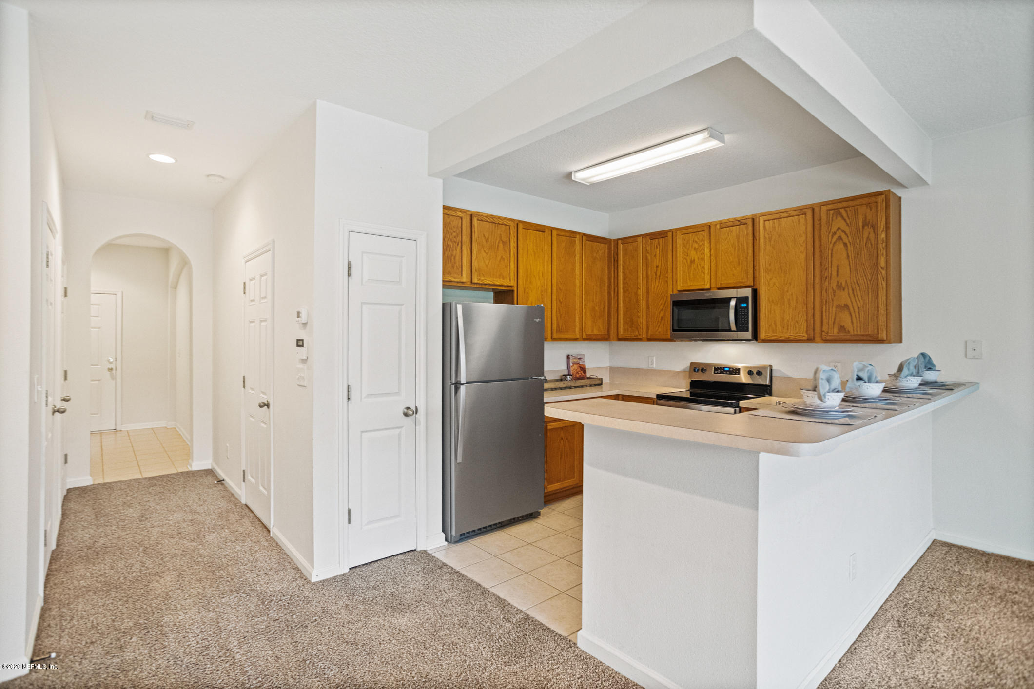 5784 Sandstone Way Jacksonville, FL 32258 - Photo 3 of 29 a kitchen with stainless steel appliances a refrigerator stove and sink