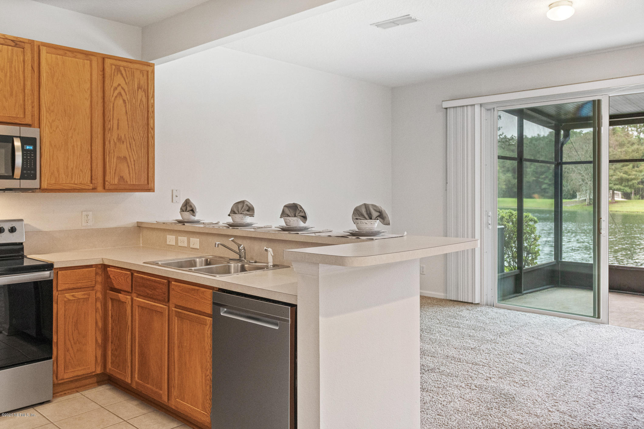 5784 Sandstone Way Jacksonville, FL 32258 - Photo 4 of 29 a kitchen with a sink stove and cabinets