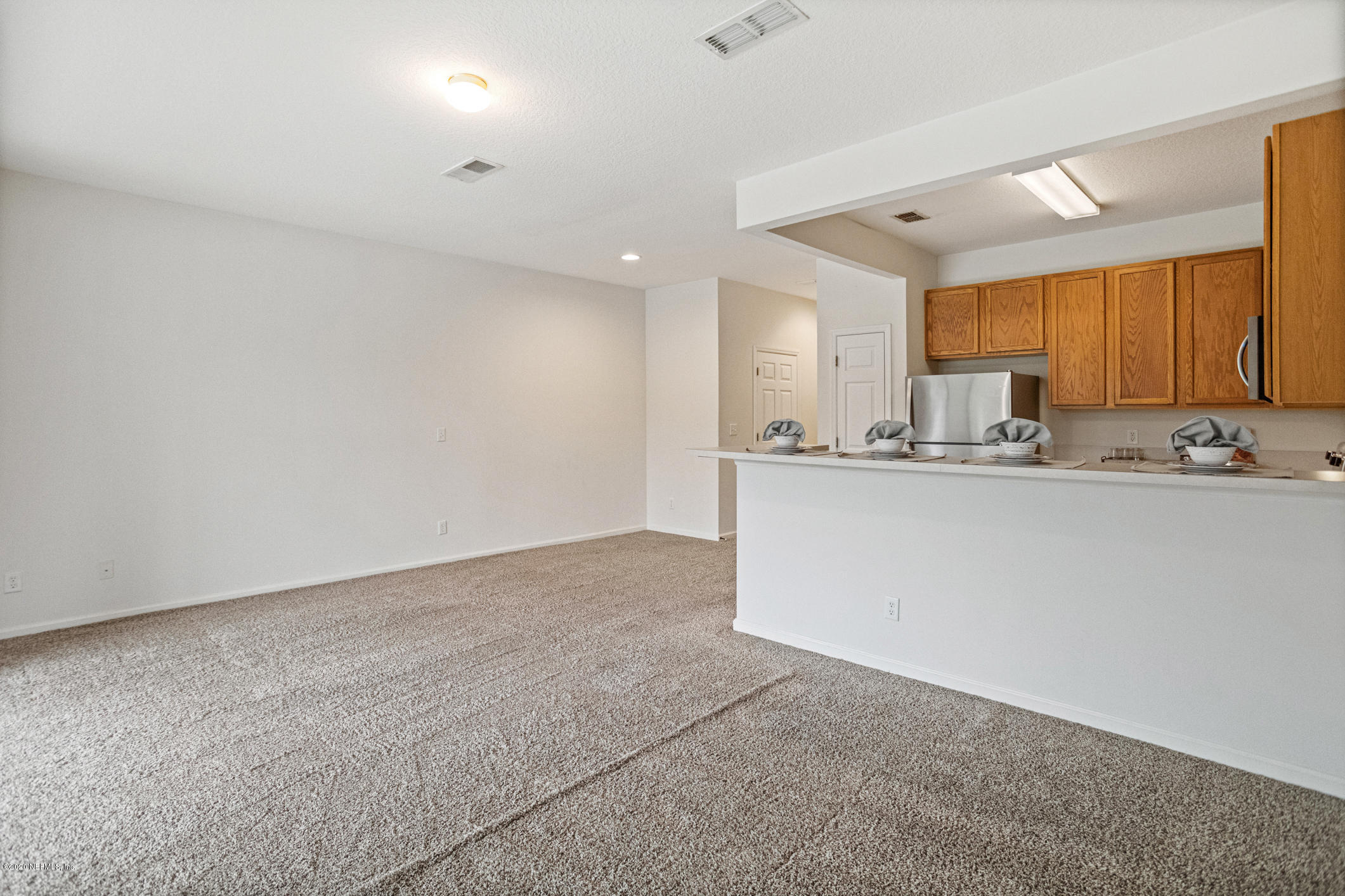 5784 Sandstone Way Jacksonville, FL 32258 - Photo 5 of 29 a kitchen with stainless steel appliances granite countertop a sink and cabinets