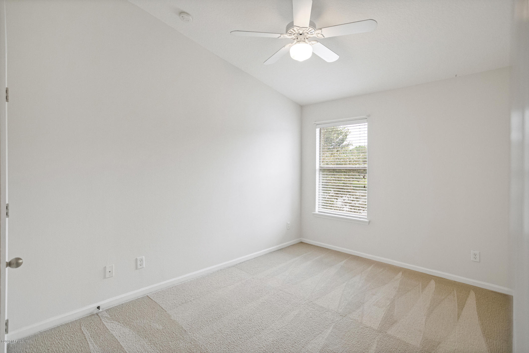 5784 Sandstone Way Jacksonville, FL 32258 - Photo 9 of 29 an empty room with a window and a fan