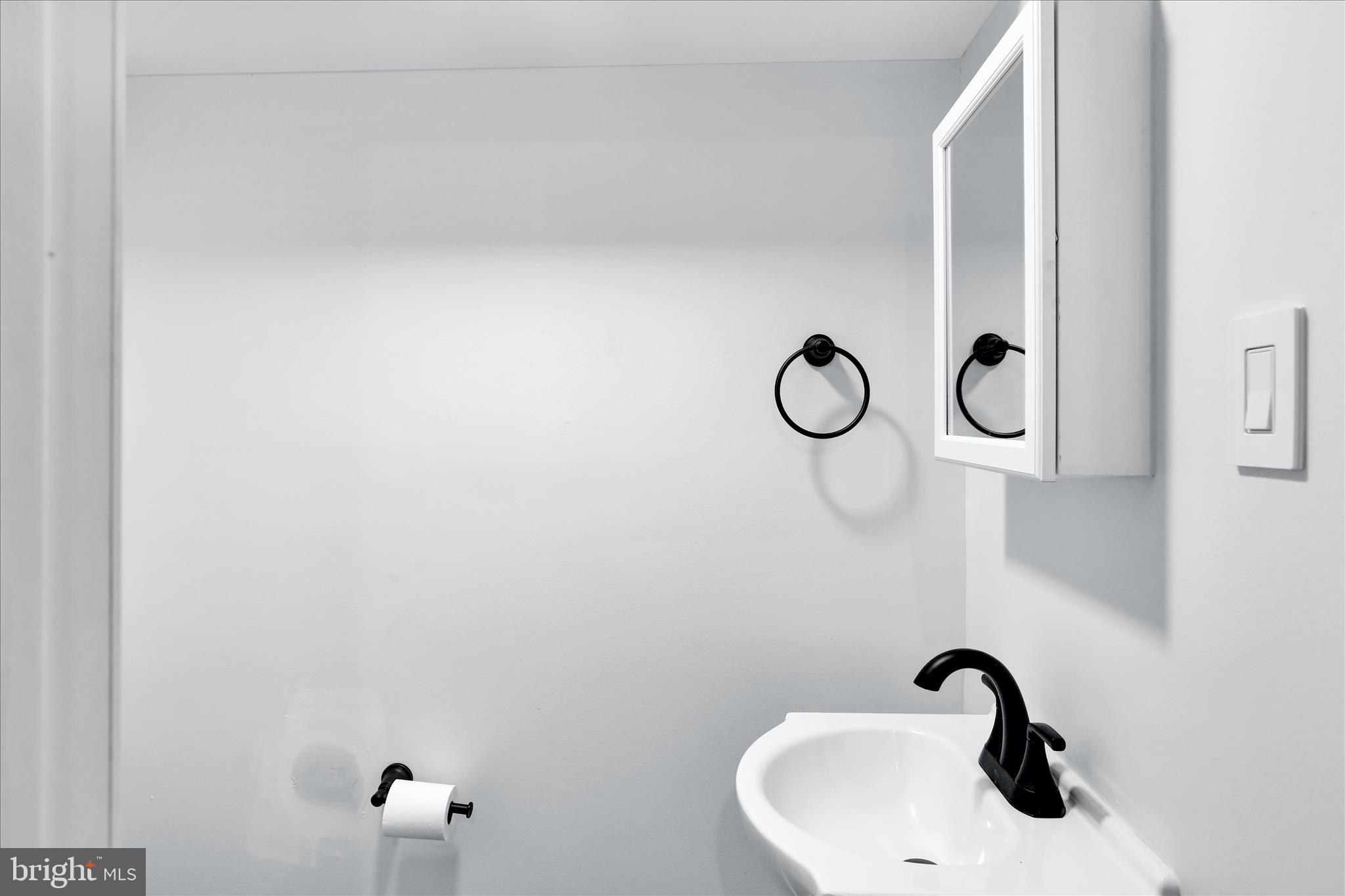 513 Manor Street Lancaster, PA 17603 - Photo 12 of 37 a bathroom with a sink and mirror