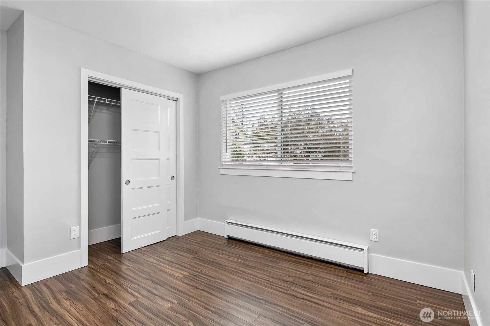 808 Northwest Market Street Seattle, WA 98107 - Photo 11 of 18 an empty room with wooden floor and windows