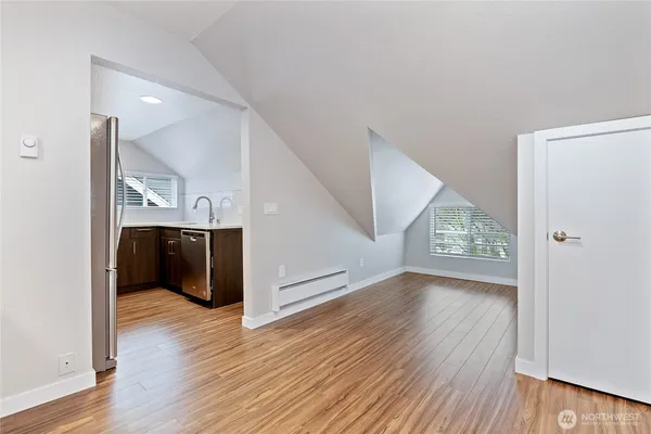 a view of a livingroom with wooden floor and staircase