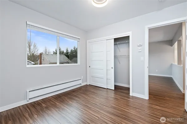 a view of a room with wooden floor and window