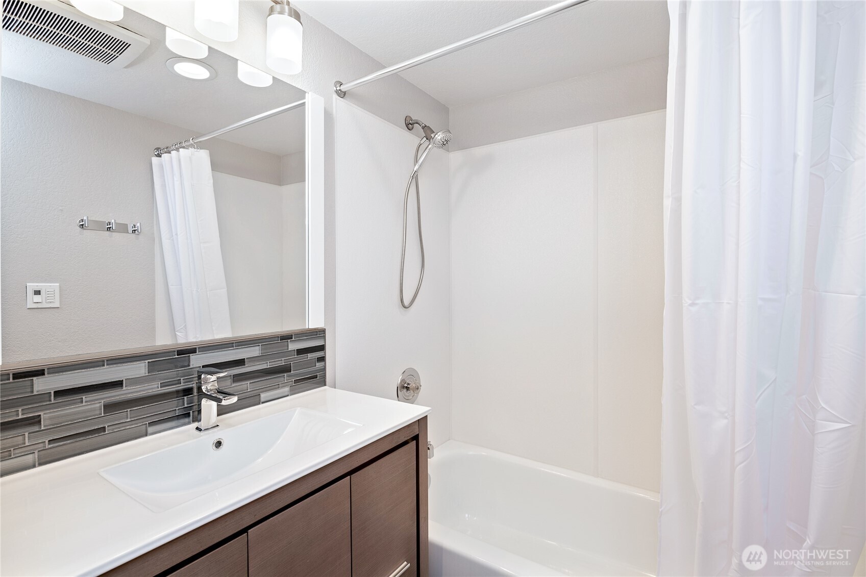 808 Northwest Market Street Seattle, WA 98107 - Photo 18 of 18 a bathroom with a sink a mirror and a bathtub